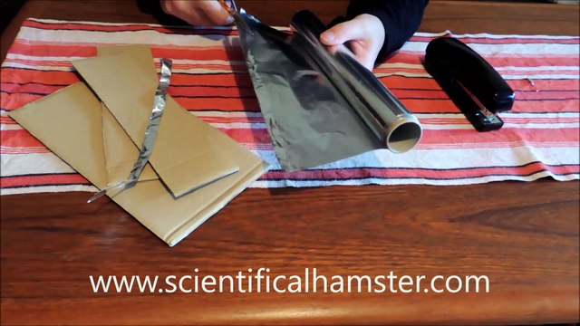 Home made slot car track of cardboard, aluminum foil and staples