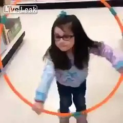 Young girl tries to hula hoop