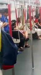 Woman on Hong Kong subway melts down when her phone battery dies.