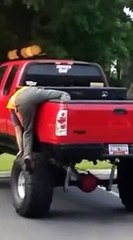 Guy trying to climb out of bed of truck into cab