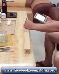 OMG what he is doing with his cell phone