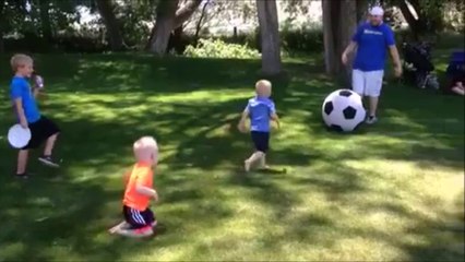 Man kicks large soccer ball and knocks down his kid!
