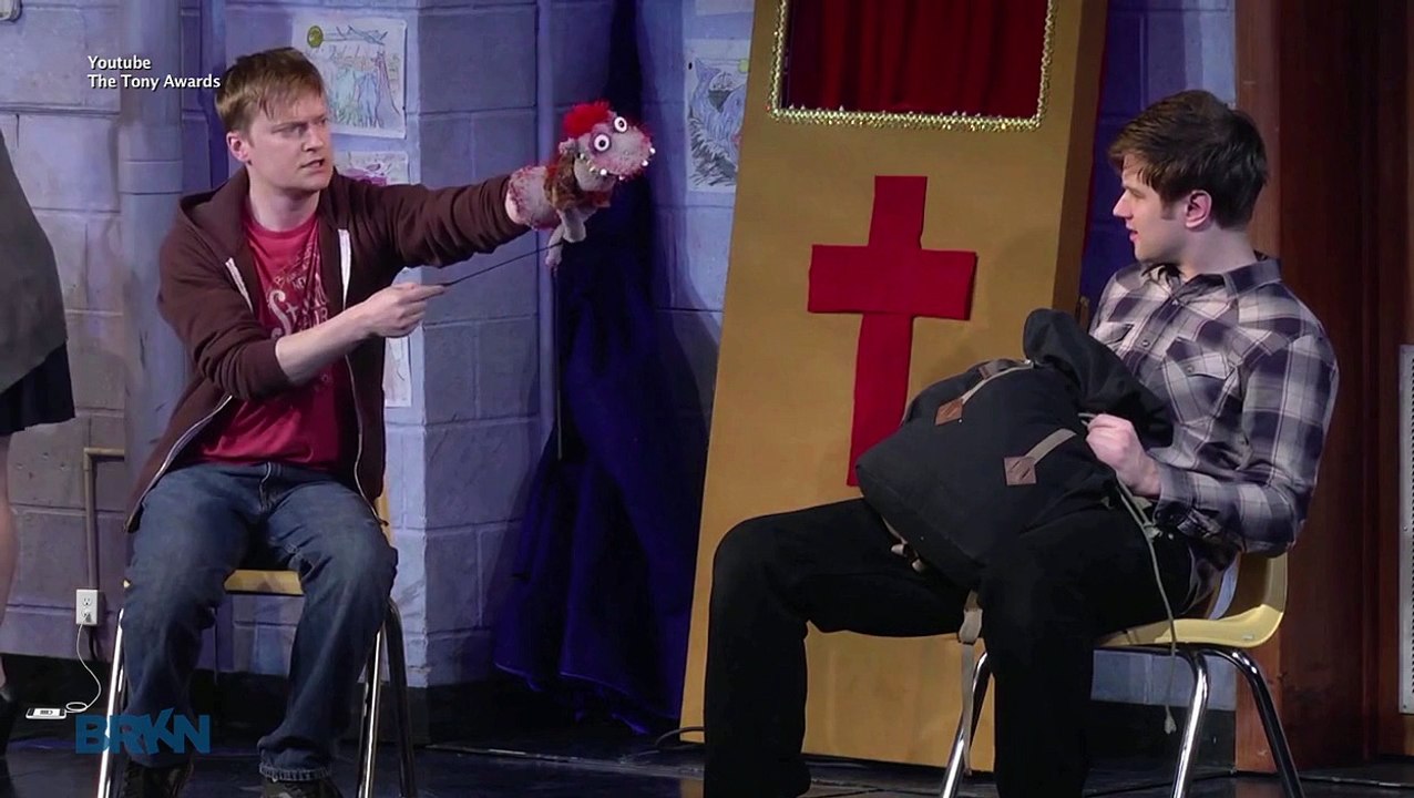 Man Charges Phone On Broadway Set