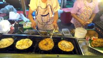 Hot pan fried mussels and seafood street food Thailand