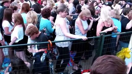 Cameraman tries to act natural after filming girl dancing at a concert