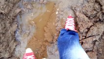 Red Chucks and Replay jeans in mud
