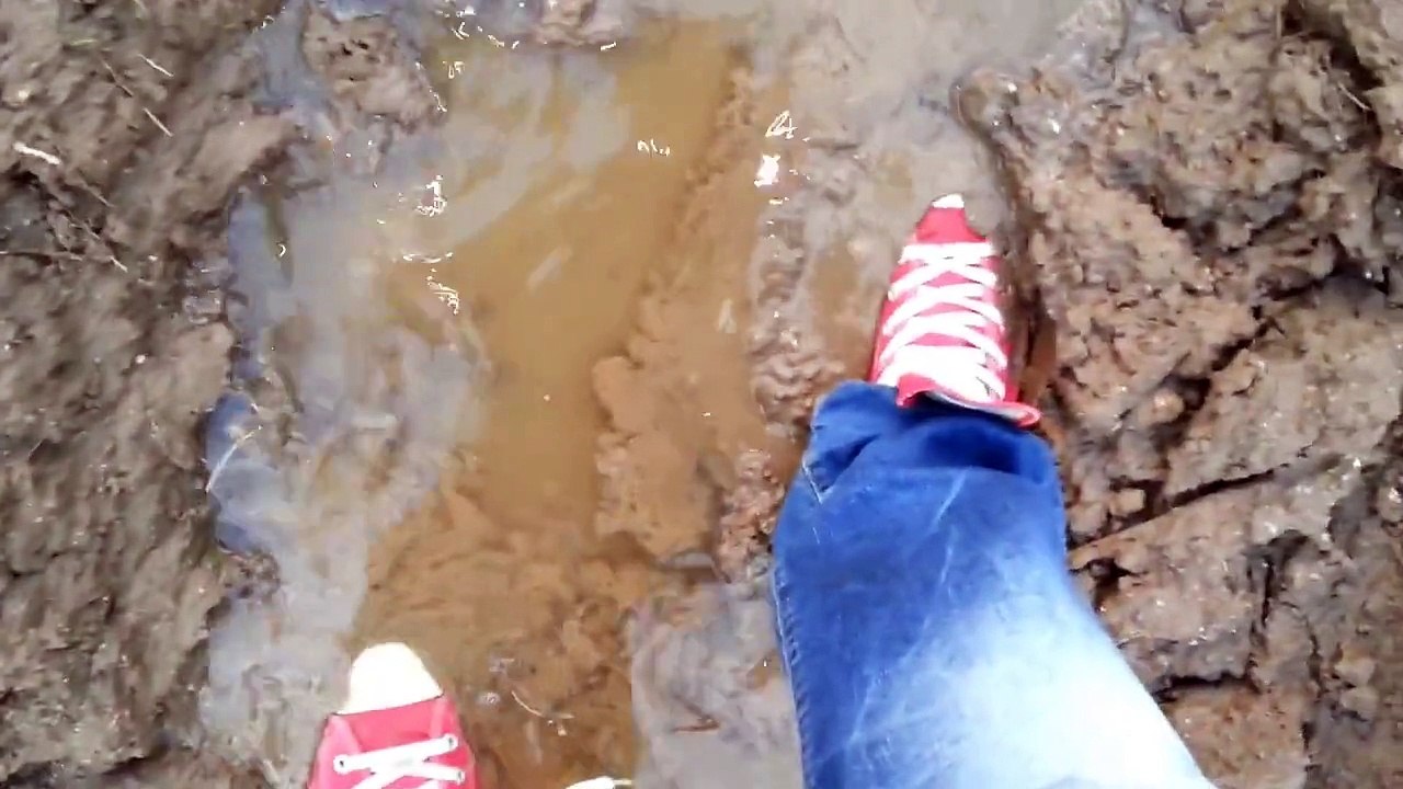 Red Chucks and Replay jeans in mud