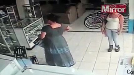 CCTV captures bizarre shop theft as woman steals plasma TV by stuffing it up her SKIRT