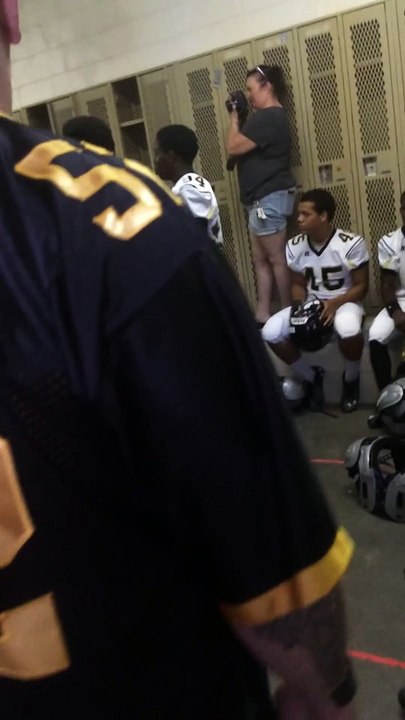 Military dad surprising teenage son before football game.