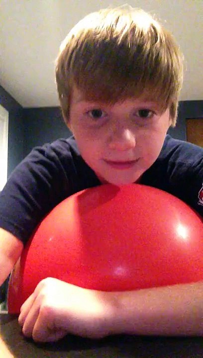 Stupid kid tries balancing on ball and fails