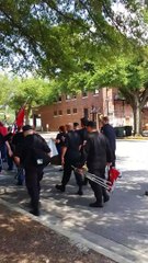 Man plays Tuba Instrument to mocks KKK Marchers