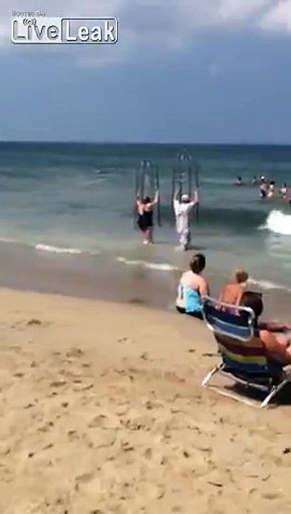 LiveLeakcom - Couple at the beach use anti-shark cages to take a dip in the sea