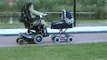 Pushing a stroller in a wheelchair.