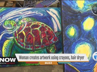 Woman creates artwork using crayons, hair dryer