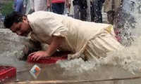 Man falls in rain water outside polling station in Gujranwala