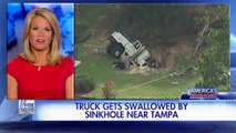Massive sinkhole swallows utility truck