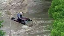 Helicopter rescue of flood victims surrounded by rushing water