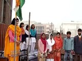 Muslim woman principal hoisting Tiranga