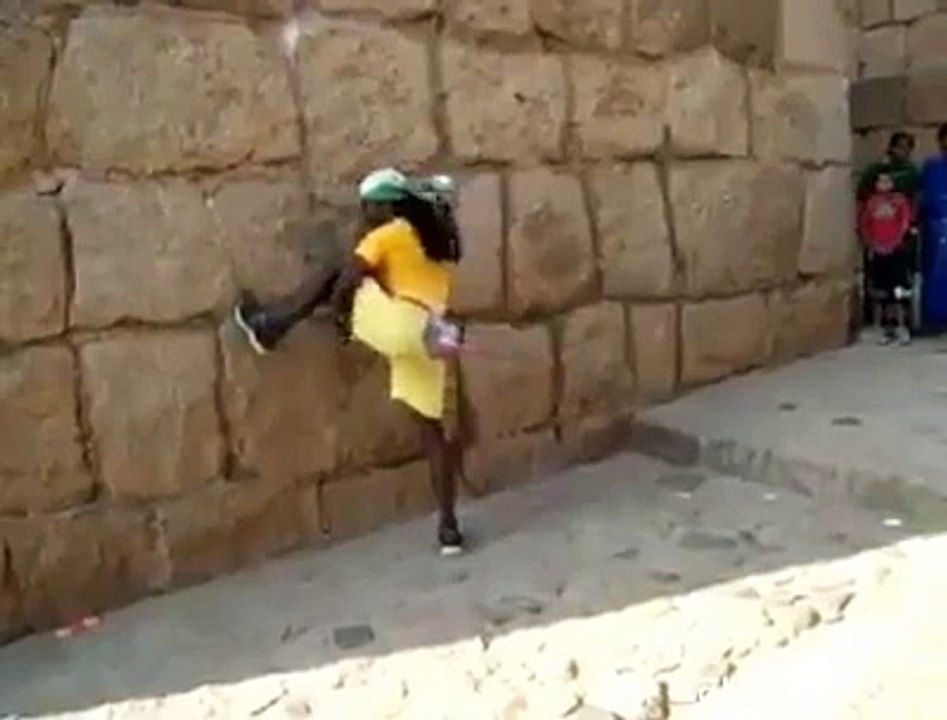 man climbing like an animal on wall