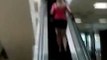 Stupid girl doesn't realize she's going up the wrong way on the escalator
