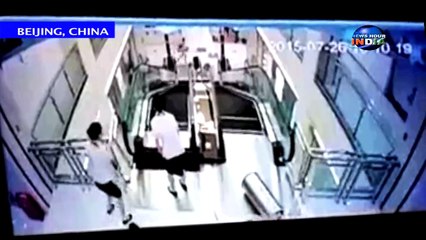 Mother crushed by escalator but throws son to safety - CHINA