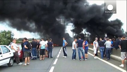 French ferry workers burn tyres to block Calais port
