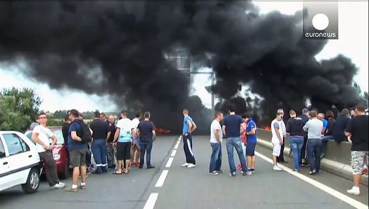 French ferry workers burn tyres to block Calais port