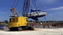 flying sailboat: crane lifts boat into water