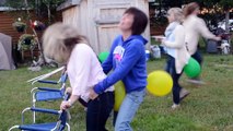 Drunk women having fun at popping ballons game