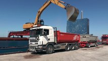 Komatsu excavator loads gravel on Scania trucks in Visby harbor 2013