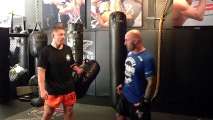 Joe Rogan kicks really hard while Duane "Bang" Ludwig holds pads
