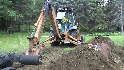 Backhoe Digging A Ditch