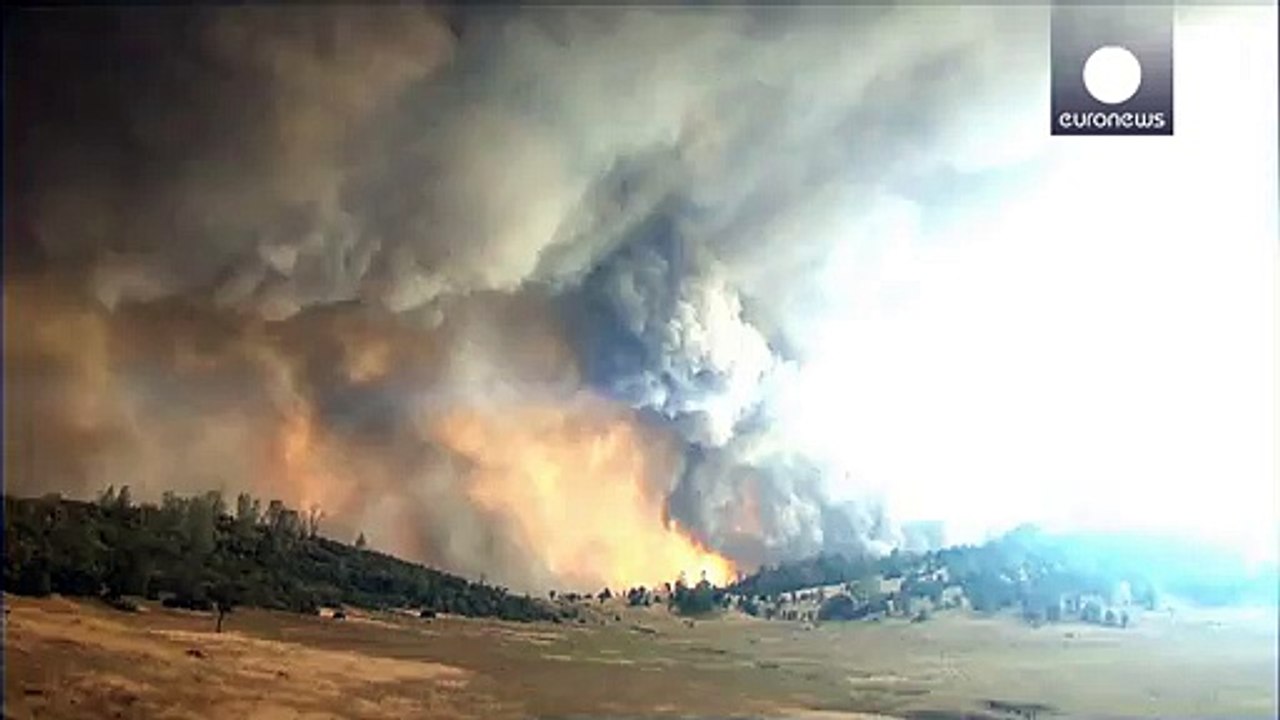 Firefighter dies as forest blazes rage across C...