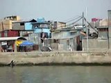 Driving by Pasig riverferry through the slums in Manila Philippines