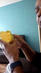 Black man sucks a mango