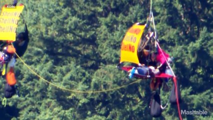 Shell Oil ship passes under Portland bridge after dangling protesters come down