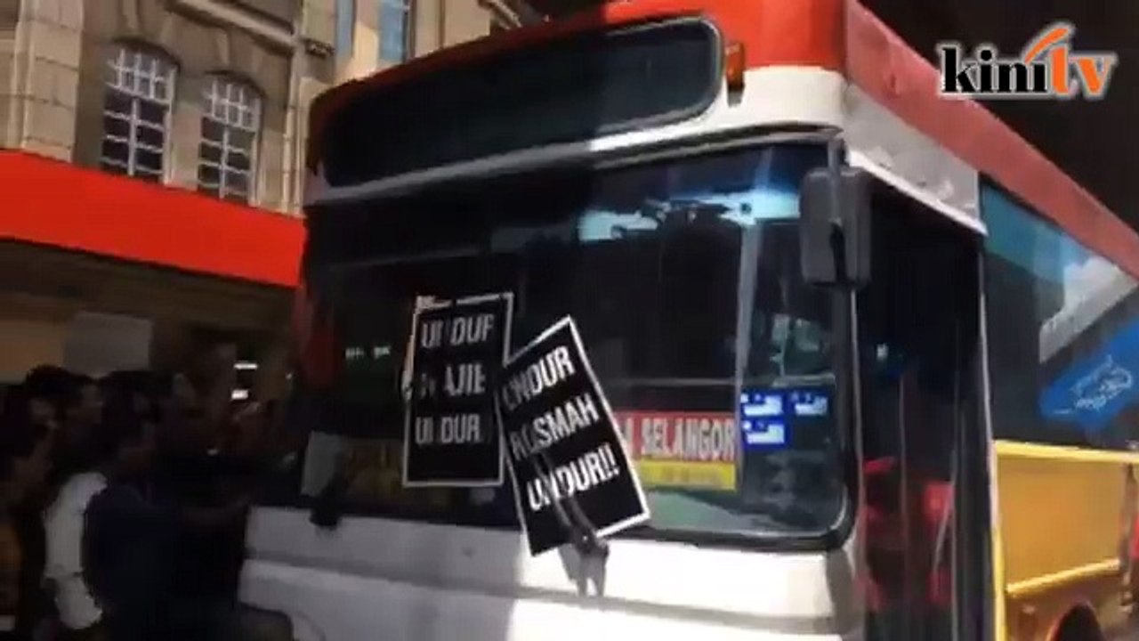 Passing bus plastered with anti-Najib posters