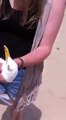 Stupid girl catches seagull at the beach with her hands!