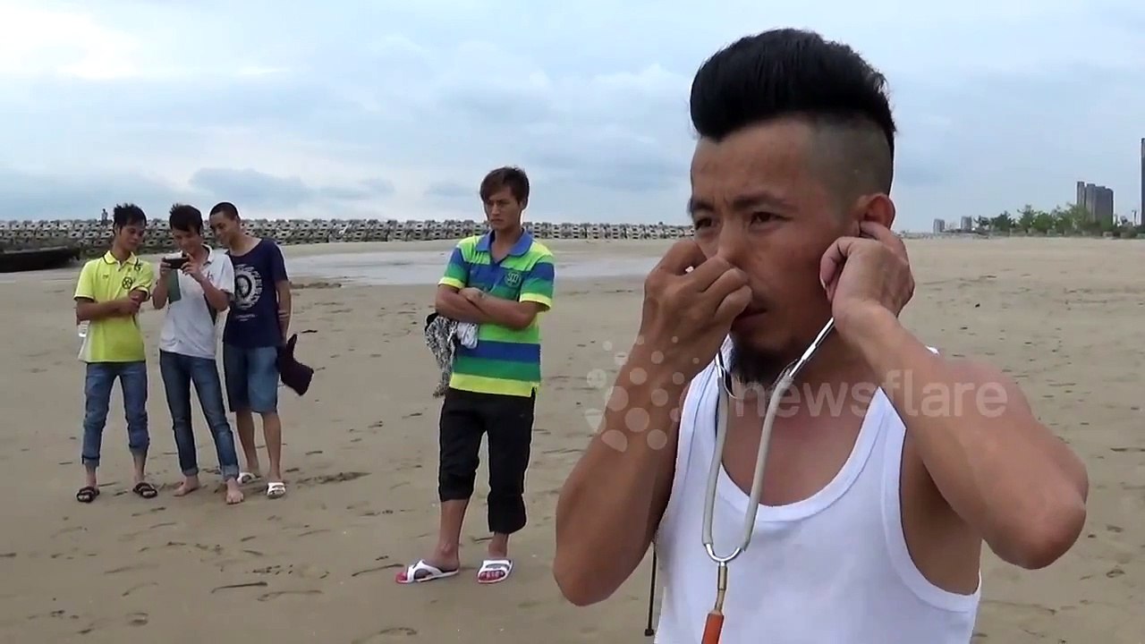 Man inflates a tyre using his ears