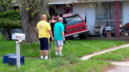 Woman crashes truck into house
