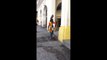 Guy with an eagle on his head walks trough Havana