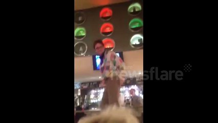 Drunk man falls off chair in Wetherspoons, London