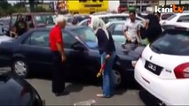 Enraged woman attacks elderly man's car with steering lock