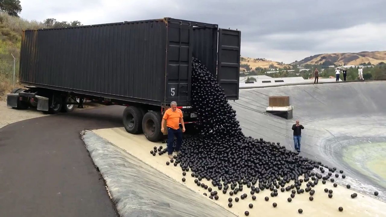 Shade balls being dumped into a water treatment Reservoir in LA... Mesmerizing !