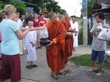 Thai Buddhist monks receiving alms