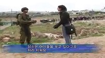 Huwaida Arraf stops Israeli soldiers from shooting people