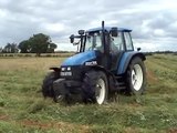 New Holland TS115 busy mowing for silage