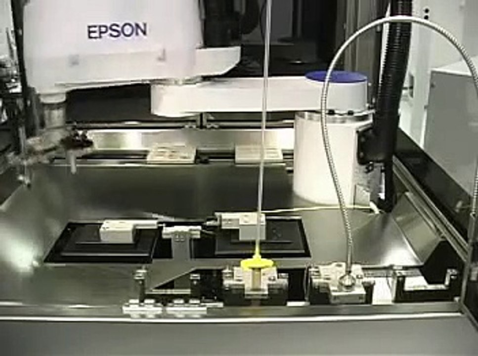 Scara robot w/ multiple tool heads doing Fiber Optic Alignem