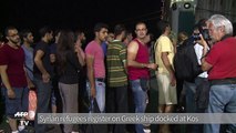 Syrian refugees register on Greek ship docked at Kos