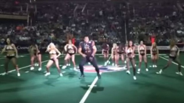 Burly Football Player Crashes Cheerleaders' Routine And Steals The Show